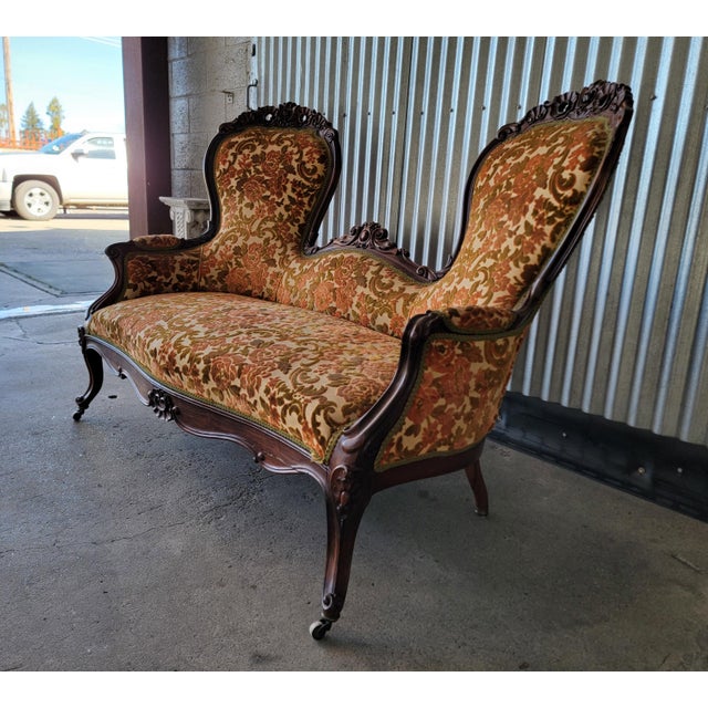 American Victorian "Balloon Back" 2 seat sofa / settee or loveseat. Hand carved from solid walnut. Older re-upholstery in...