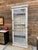 This antique, weathered display case has been fully restored. It is glass-enclosed on three sides, allowing for a...
