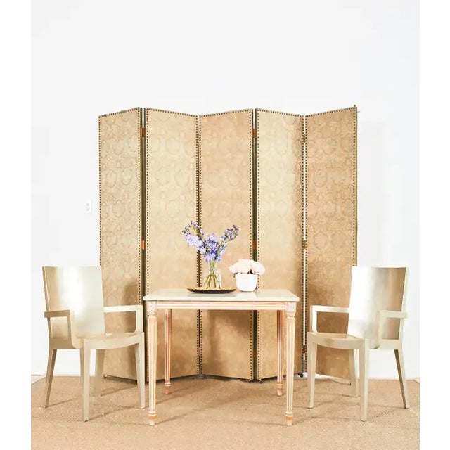 Spectacular set of Karl Springer JMF dining chairs featuring an ethereal lacquered silver leaf square gilt finish. The...