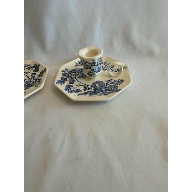 Pair of vintage Mason's Manchu blue and white ironstone chamberstick candle holders. These elegant pieces feature a...