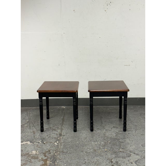 Design Plus Gallery presents a Pair of Two Tone Side Tables. Each table offers a square top in a medium brown wood tone...