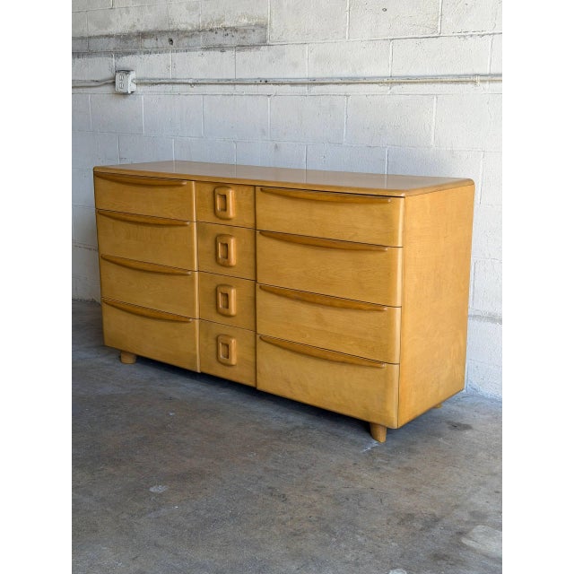 This vintage bedroom credenza features a streamlined multi-drawer layout highlighted by an iconic stepped configuration...