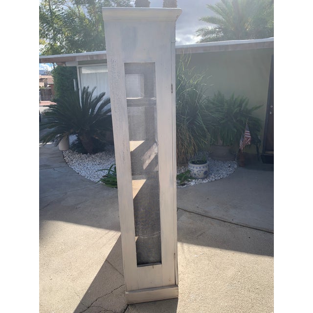 Here we have a darling antique screened wooden pie safe. I believe this old cabinet is made from fir wood and is mostly...