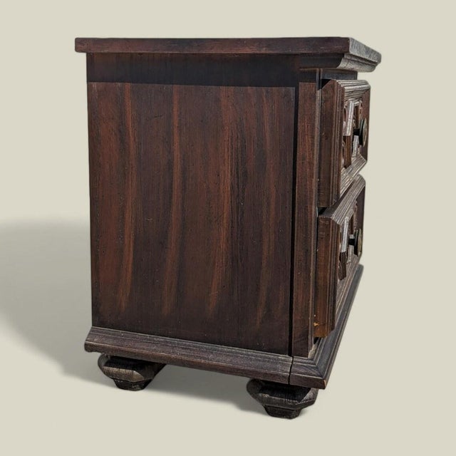 Bring timeless design into your home with this 1970s Spanish Revival nightstand in dark carved wood. Design Highlights: A...