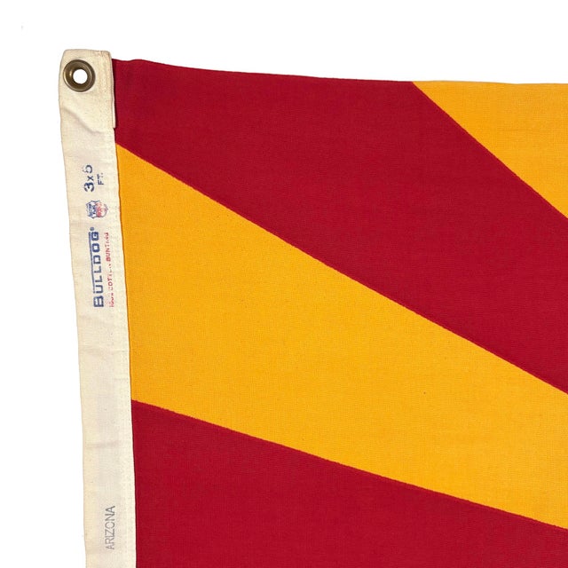This vintage Arizona flag is made from a cotton cloth, with printed design visible on both sides, and lighter coloring on...