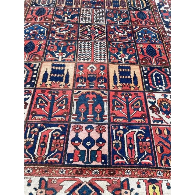 Beautiful midcentury rug with a geometric and stylized floral design, and beautiful colors, entirely hand knotted with...