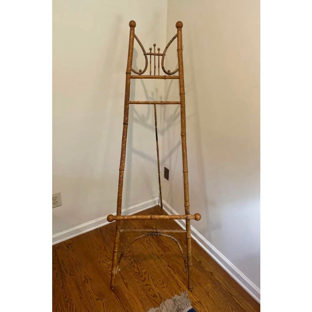 A wonderfully decorative antique scorched bamboo floor easel, dating to the late 19th or early 20th century and displaying...