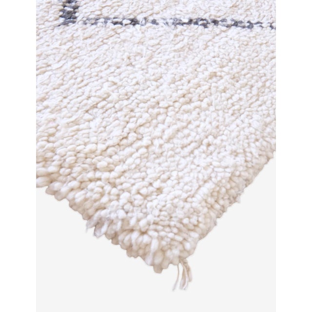 Experience ultimate coziness with our Moroccan Beni Ourain Wool Rug. Made with natural fibers, this 9.3 x 6.7 ft rug adds...