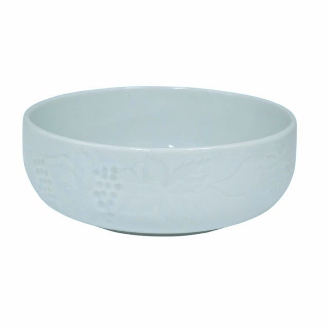 A refined vintage Korean celadon bowl set featuring a delicate grape and vine relief pattern encircling each form. The...