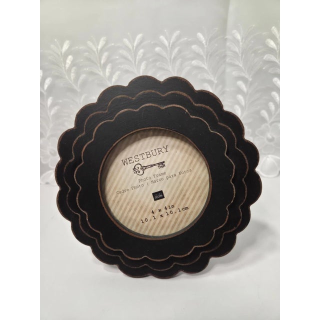 This charming Westbury black round wood photo frame features a beautifully detailed three-layer scalloped design that...
