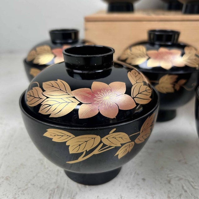 Beautiful set of 10 Japanese covered food bowls in the original wooden box. The bowls are made of wood and coated with...
