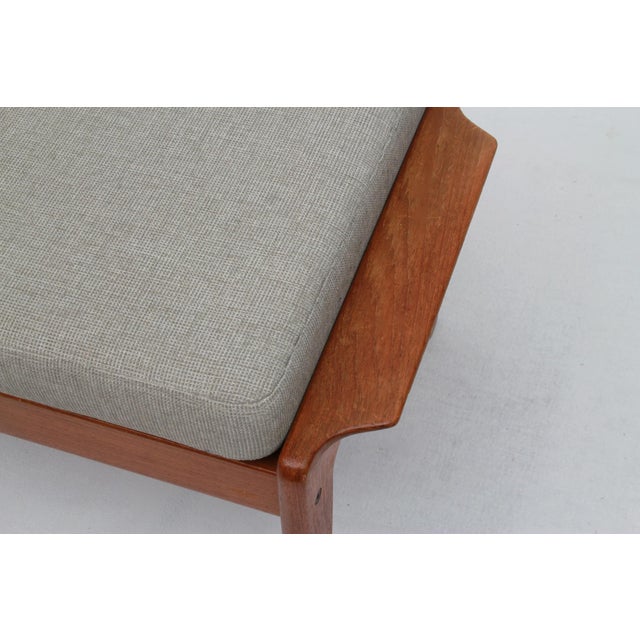 Classic teak stool/footstool. Designed by Arne Wahl Iversen for comfort. The removable cushion has been freshly...