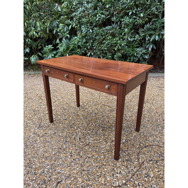 19th Century Georgian Mahogany Side Table with chamfered legs, two drawers with brass knob handles Circa: 1830 Dimensions:...