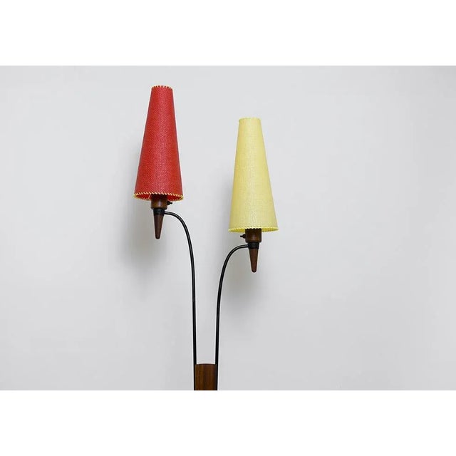 Original design from the 1950s. A floor lamp with two lampshades that can be illuminated separately or together. Base and...