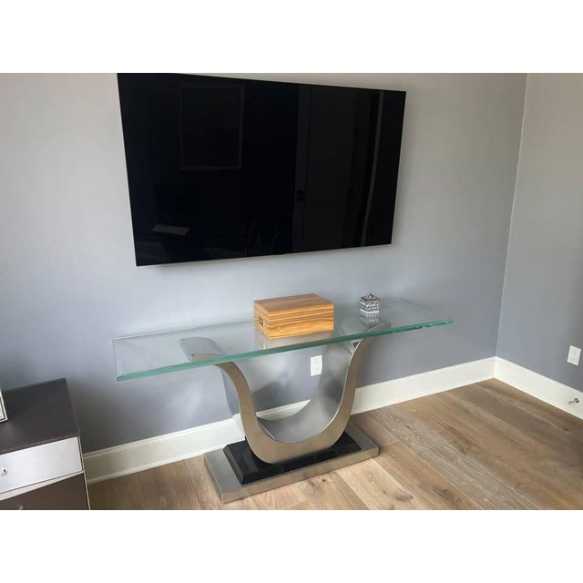 Elite Modern contemporary console table purchased at Cantoni in Dallas. A thick tempered-glass top rests above a...
