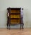 A late Victorian mahogany display cabinet featuring glazed double doors with flowing carved decoration, bevelled teardrop...