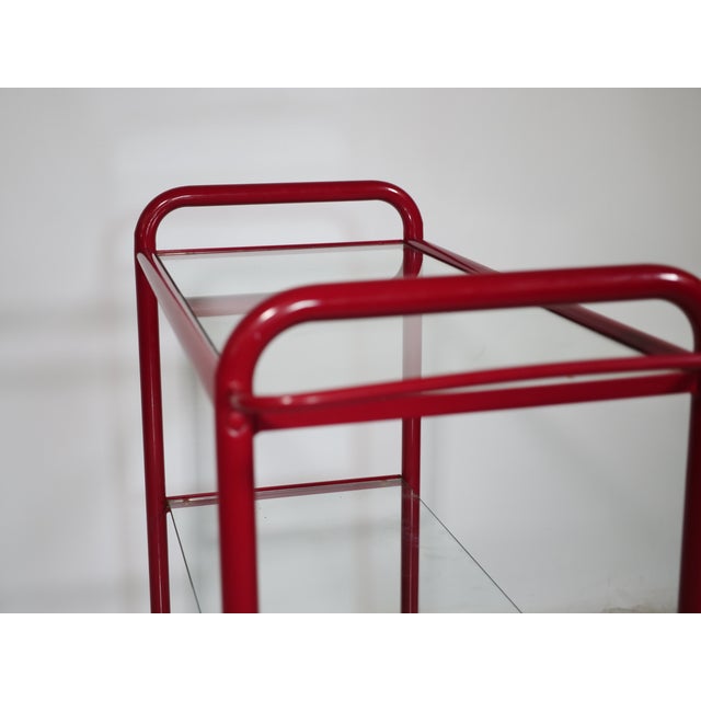 Metal and glass trolley from the 1980s. Clean, functional design with multiple glass shelves on a rolling metal frame....