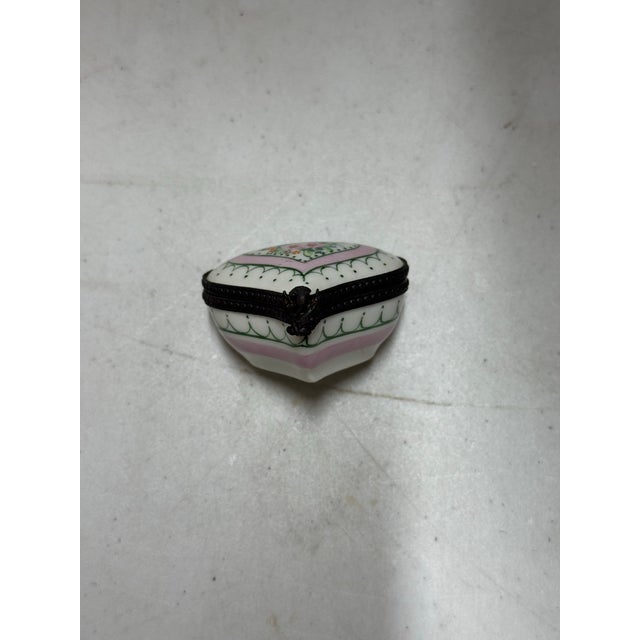 This is an antique porcelain Limoges box. It depicts a heart with a botanical pattern. There are also polka dots and other...