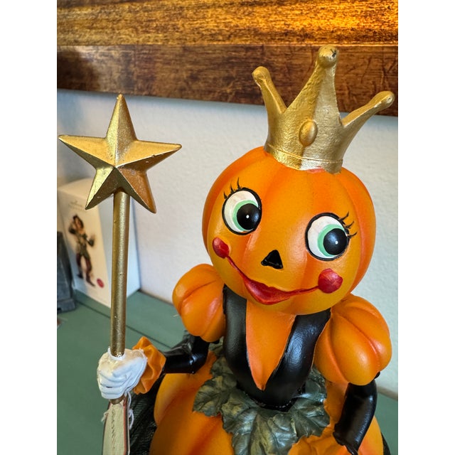 Whimsical. Cheerful. Vintage Inspired Halloween Girl, Pumpkin Head Sculpture, with a Crown and Wand with Star. She is...