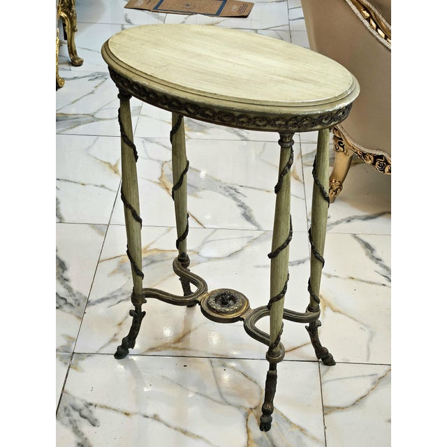 Bring distinctive character to your interior with this one-of-a-kind French-inspired side table. Its elegant oval tabletop...