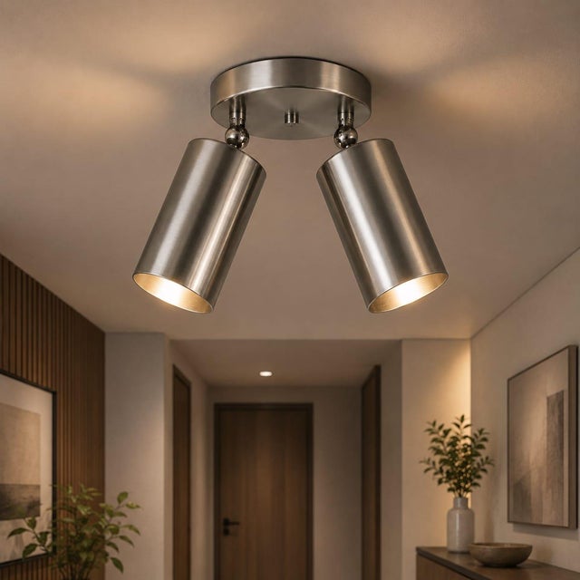 Crafted in solid brass, this double spotlight ceiling light features two cylindrical shades mounted on adjustable joints,...