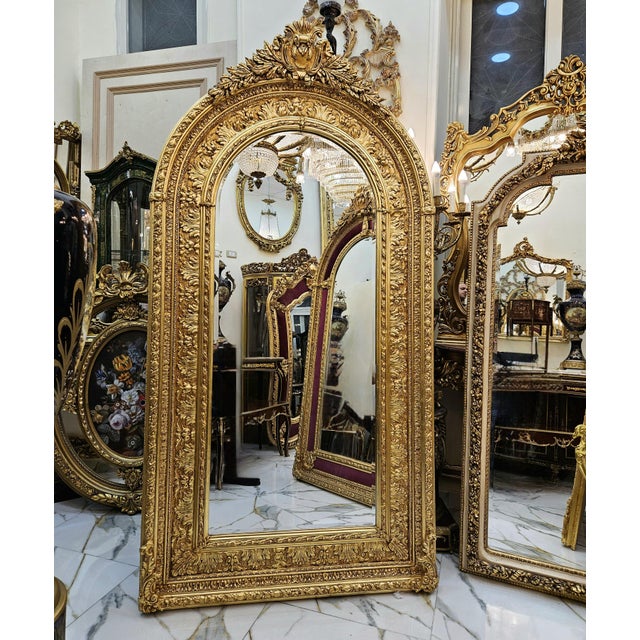 Create a truly majestic focal point with this grand French Baroque–style arched mirror, featuring an exceptionally ornate...