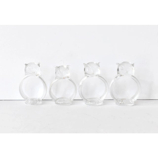 A set of 4 vintage, mid-century blown glass napkin rings or napkin holders, each owl with a different expression.