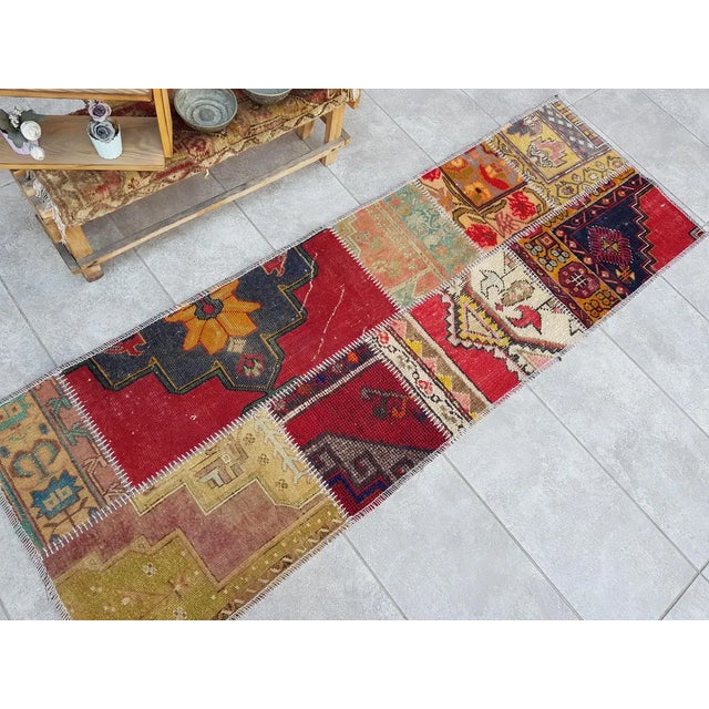 This is a vintage Turkish Oushak rug from the Mid 20th Century. The piece was hand-knotted.