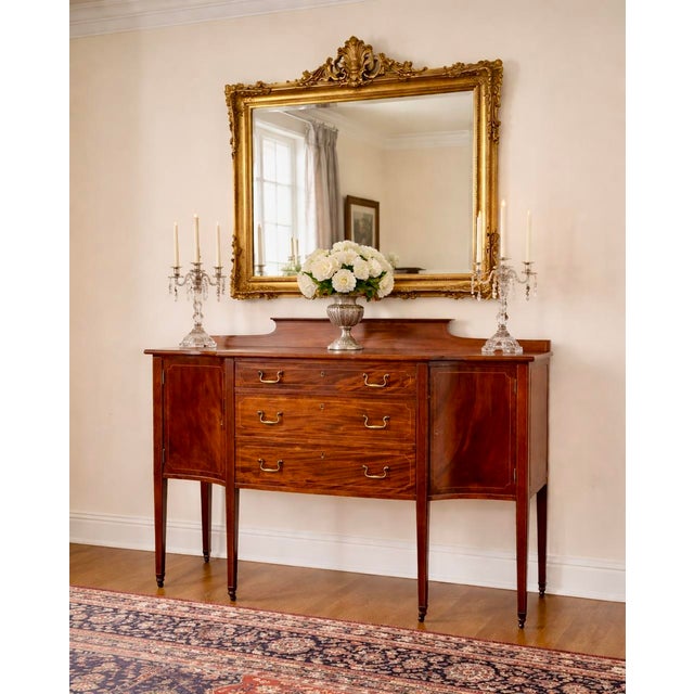 Mahogany Sheraton Style Sideboard dating to circa 1880-1910 with stunning flame mahogany veneer and rich period detail....