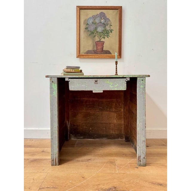 A beautiful shopkeeper’s desk. An early 20th century French panelled piece in a gorgeous shade of old purple paint with...