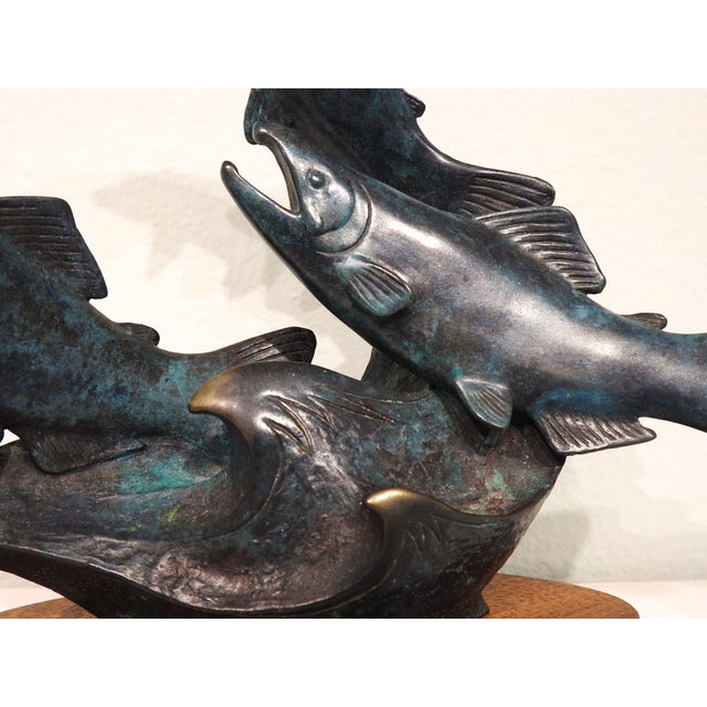 1986 bronze salmon sculpture by Jacques and Mary Regat (20th, 21st century) Alaska. Verdigris patina bronze on wood base....
