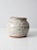 A beautifully handcrafted vintage studio pottery jar featuring a speckled off-white finish, ridged surface design, and a...