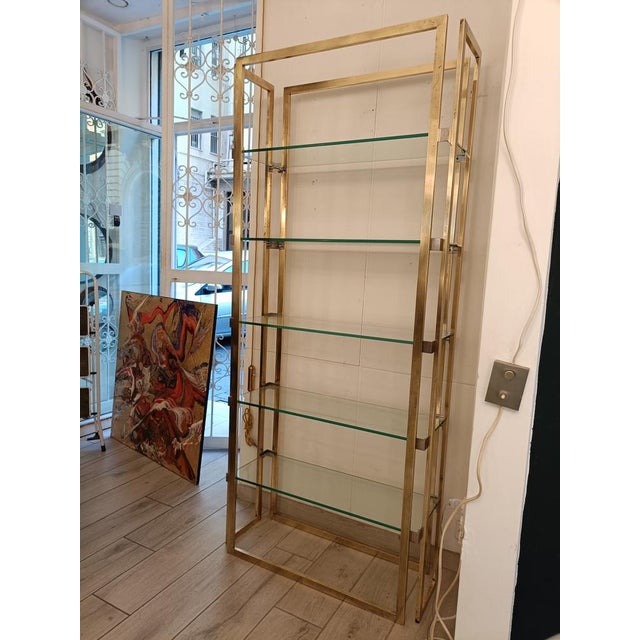 Etagere made entirely of high-quality brass in a beautiful gold color with five clear glass l-tops that together create a...