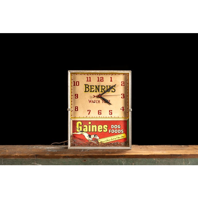 Mid-20th-century advertising wall clock manufactured by Benrus Watch Co. of New York for Gaines Food Co. of Sherburne, New...