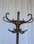 Vintage bentwood coat stand made from dark brown curved wood. The design features elegantly curved hooks, decorative...