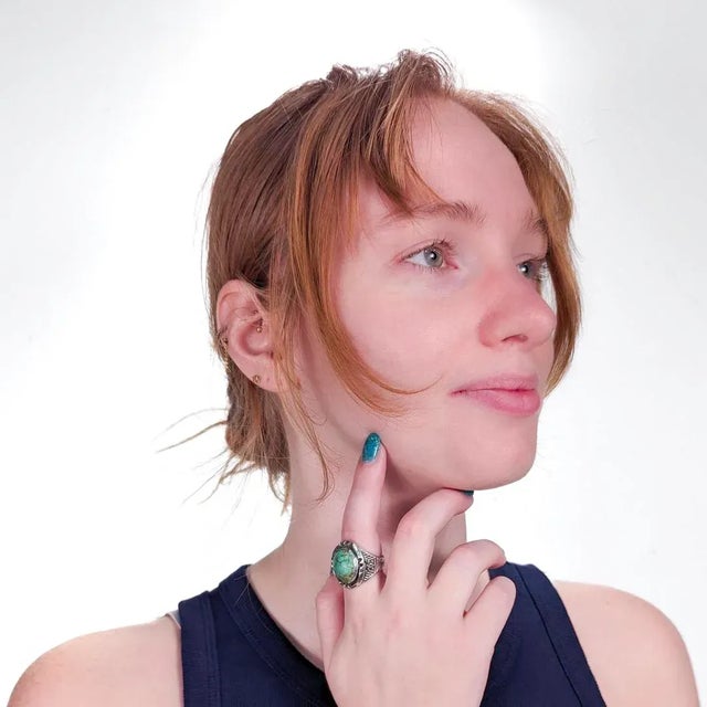 A fine vintage Navajo ring. In silver and bezel set with a large oval turquoise cabochon. Worked throughout with hand...