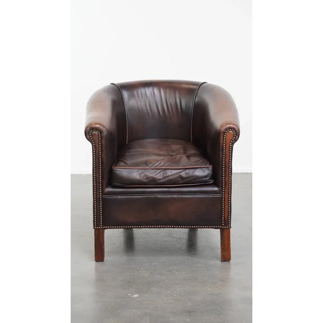 Comfortable sheepskin wing chair with a beautiful warm color scheme and refined stitching on the sides. : This subtle,...