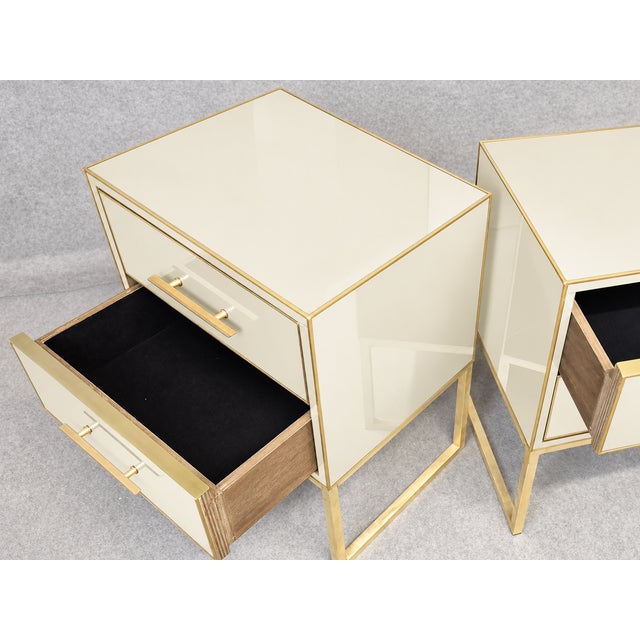 An ivory Murano glass exterior gives this two-drawer bedside pair a calm, sculptural look. Polished brass outlines the...