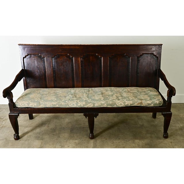 Dimensions: 39 ⅞” H x 72 ¼” W x 26 ¼” D A circa 1780 English oak "settle bench" (hall bench) of stately carved details....