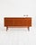 Teak sideboard with three hinged doors, three upper drawers, and a raised structure on linear legs. Scandinavian...