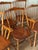 A set of six vintage Windsor-style dining chairs, including four side chairs and two armchairs. Crafted from solid wood,...