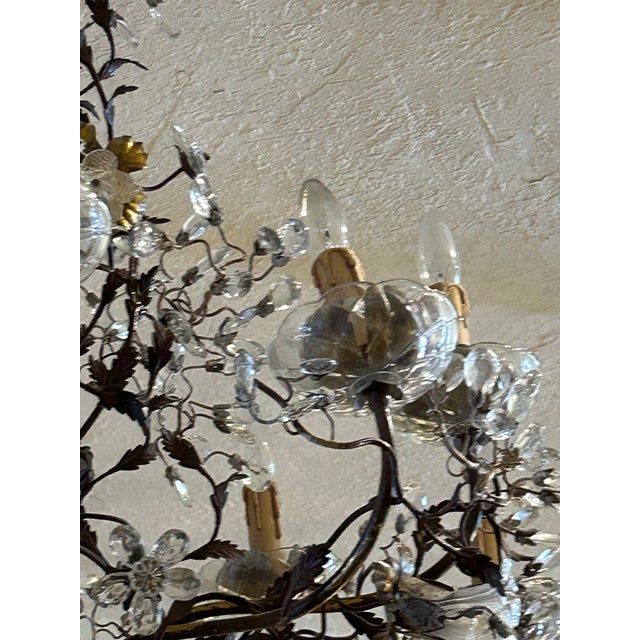Charming vintage 10 light Italian floral chandelier crafted in metal with a gilt finish and decorated with floral crystal...
