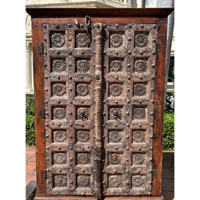 An extraordinary 18th-century Indian armoire, masterfully crafted from solid teak and showcasing exceptional hand-carved...