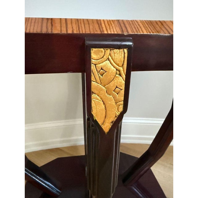Art Deco Octagonal End Table This table has a distinctive elongated octagonal shape with four angled legs terminating on a...