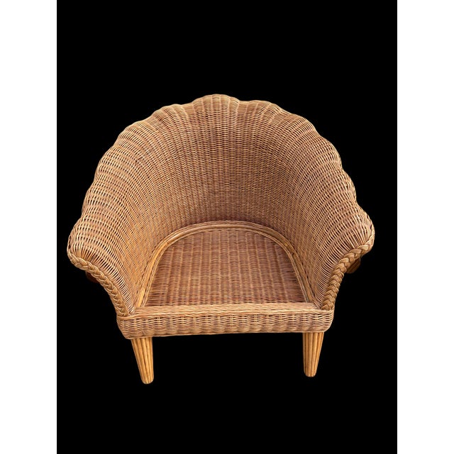 Fabulous and extremely well made vintage wicker and wood scalloped shell club chairs with wood legs. They have a lip at...
