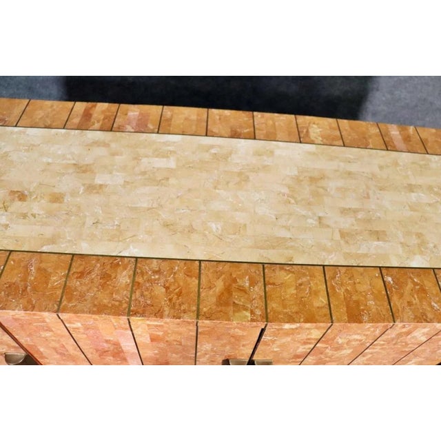 Vintage cabinet made with tessellated stone with inlaid brass trimming. Made in an art deco fashion with ample storage for...