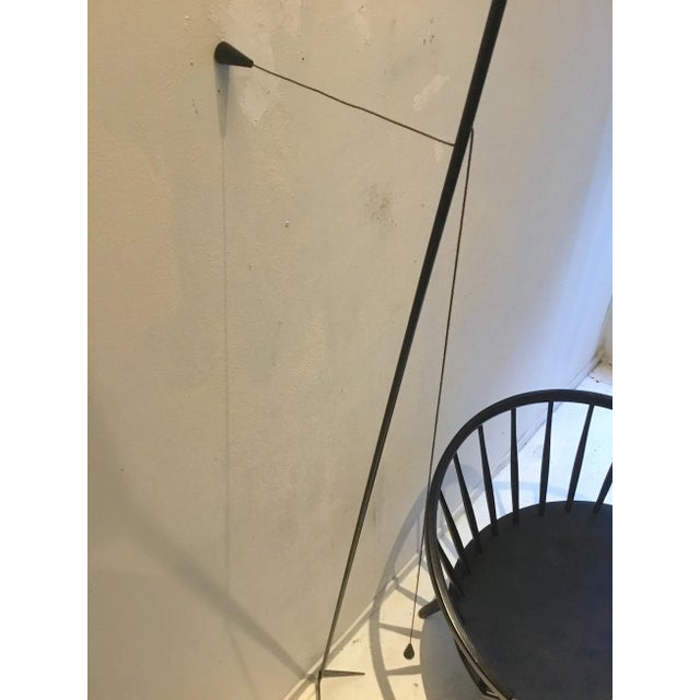 This uplighter is mounted to the wall with a wire. The wire-mechanism also allows for the lamp to be adjusted. European...