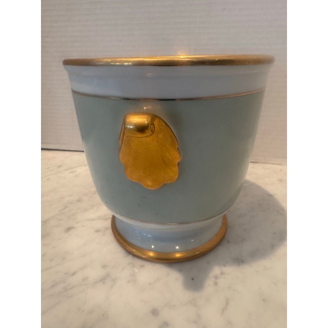 A beautiful vintage robin's egg blue cachepot with gold handles on each side.