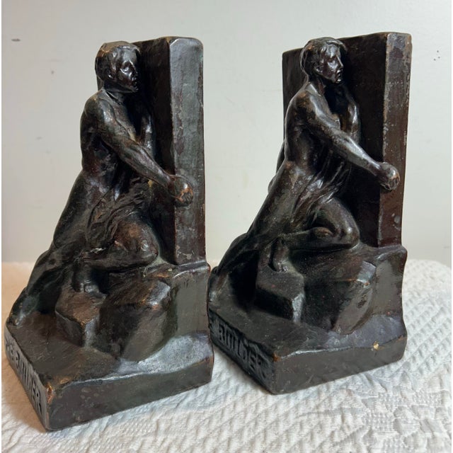 Antique Pompeian bronze clad bookends of a man entitled ‘The Builder’. Great condition.