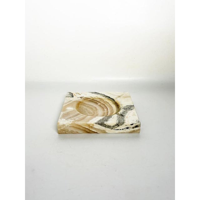 French onyx ashtray dating from the 1970s. Carved from a solid piece of natural stone, the ashtray features a square...
